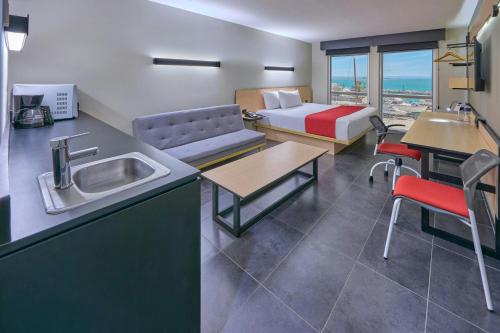 a kitchen with a sink and a room with a bed at City Express by Marriott La Paz in La Paz