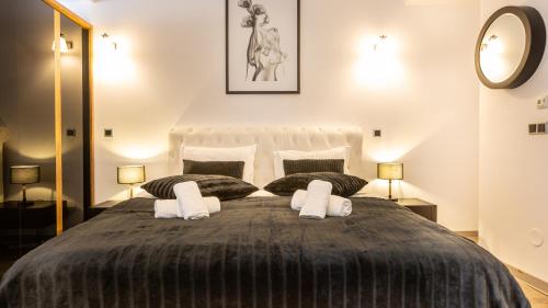 a bedroom with a large bed with two pillows at Zen Retreat Studio in Silver Mountain in Poiana Brasov