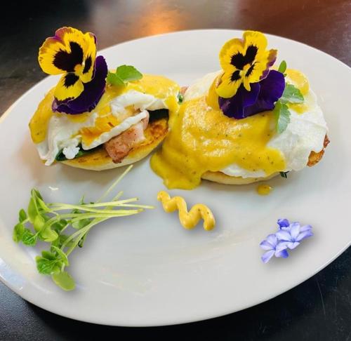 a white plate with two breakfast sandwiches with flowers on it at Lavender Lane in Ladysmith