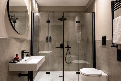 a bathroom with a shower and a sink and a toilet at Hotel Principe Di Villafranca in Palermo