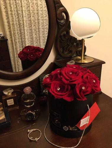 a box of roses sitting on a table next to a mirror at Mary's Archontiko in Mesaria