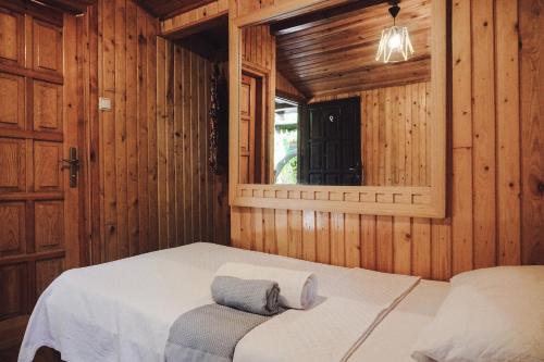 a bedroom with a bed in a wooden room at Base Bungalows in Olympos