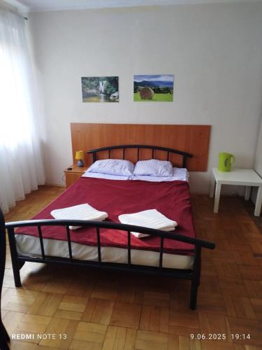 a bedroom with a bed with a red comforter at Pokoje Karpacz in Karpacz