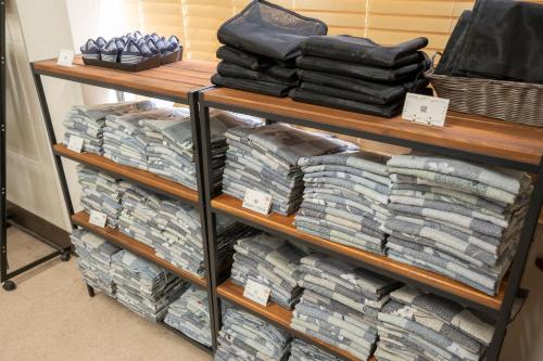 a room with two shelves filled with lots of towels at Le Nessa Jyogasaki in Ito