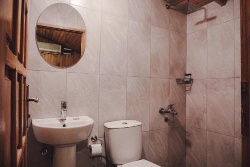 a bathroom with a toilet and a sink and a mirror at Base Bungalows in Olympos