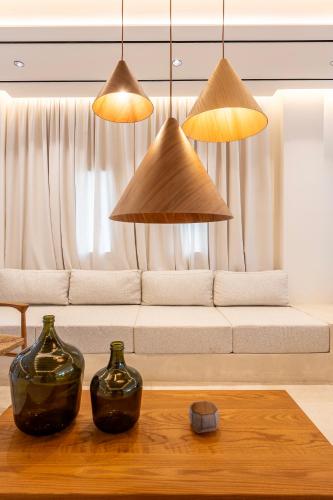 a living room with a couch and two vases on a table at Aegean Houses in Kos Town