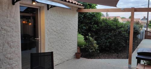 a door to a house with a tv on the side at Studio Cosy proche Futuroscope in Montamisé