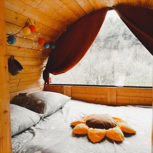 un lit dans une chambre avec une grande fenêtre dans l'établissement Brin d'Ardèche, à Saint-Prix