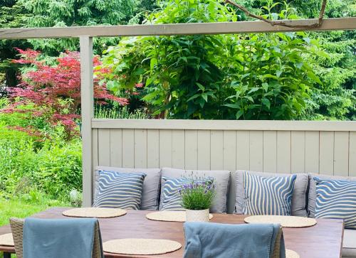 a table with pillows and chairs on a patio at Familienfreundliches Landhaus "Karin" mit Pool in Struppen