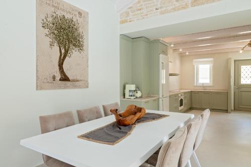 a kitchen with a white table and chairs at Parga Villas in Parga