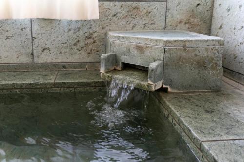 a fountain in a building with water in it at Le Nessa Jyogasaki in Ito