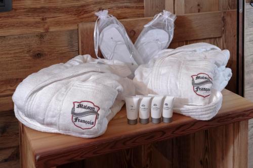two towels are sitting on a wooden shelf at Ski Apartment Francois Hot Tub & Central Location with hotel services in Breuil-Cervinia