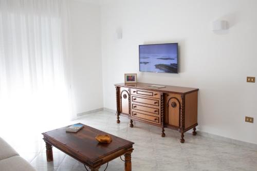 a living room with a tv and a coffee table at Tra il Vesuvio e il Mare Apartment in Torre del Greco