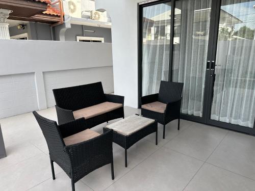 two chairs and a table on a balcony at Eakmongkol Luxury Five-Bedroom Pool Villa in Jomtien Beach