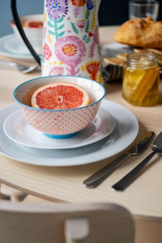 a grapefruit in a bowl on a plate on a table at The Art Loft in Kingsbridge