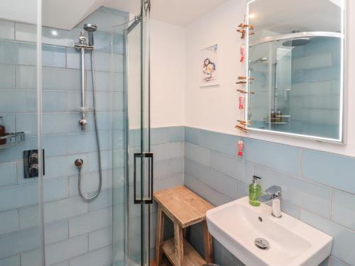 a bathroom with a sink and a shower at Puffin Cottage in Alnwick