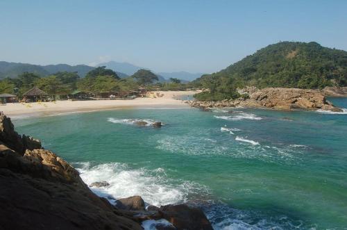 a view of a beach with rocks and the ocean at Canto de Paz Trindade Hospedagem in Trindade