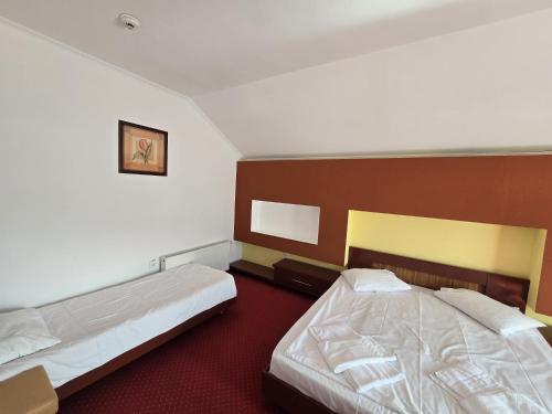 a hotel room with two beds in it at Casa Maria Azuga by Genco in Azuga