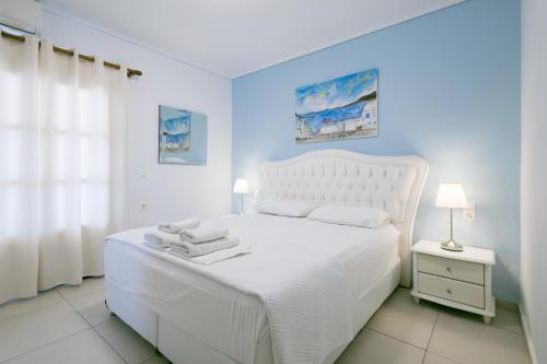 a white bedroom with a white bed and a window at Anna Maria - Vanessa Apartments in Neo Klima