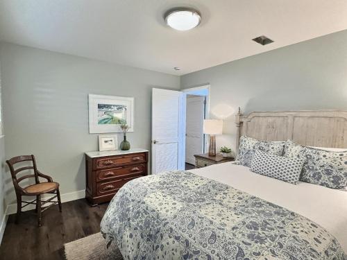 a bedroom with a bed and a chair at Gem Of The Sea - 3142CY in Cayucos