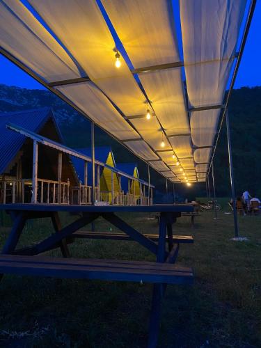 a picnic table with a large tent over it at Yelken Bungalows in Eskiömerler