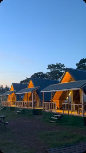 a row of lodges at night with the lights on at Yelken Bungalows in Eskiömerler