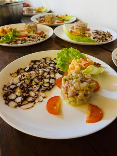 a plate of food on a table with plates of food at A casa di Giorgia lodge Nosy be Andilana in Nosy Be