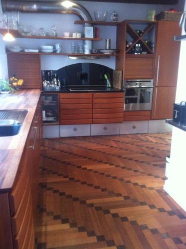 a kitchen with wooden floors and a counter top at Beautiful townhouse with a garden in the best location in Copenhagen in Copenhagen