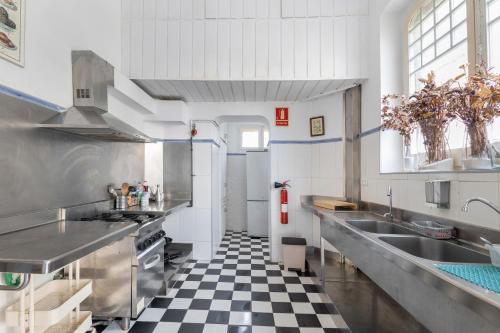 a kitchen with black and white checkered floor at Villa Antonia in Sant Vicenç de Montalt