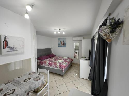a small bedroom with a bed and a table at Countryside Studio Apartment Valentina in Vrh