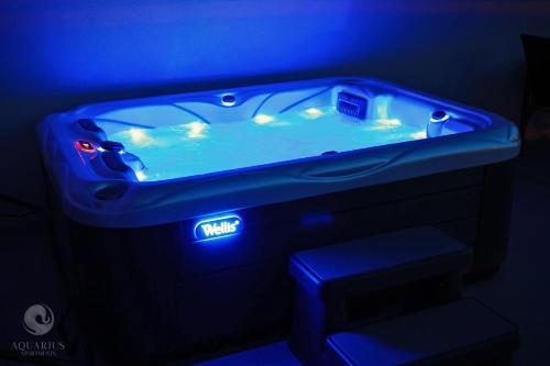 a blue bath tub in a blue room at Aquarius Apartments in Miskolctapolca