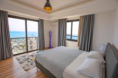 a bedroom with a bed with a view of the ocean at BlueRoza Elegant Sea View by HolidayKeys in Kérynia