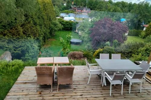 a wooden deck with a table and chairs on it at Båt huset in Halmstad