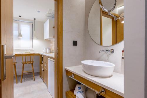 a bathroom with a sink and a mirror at Aegean Houses in Kos Town