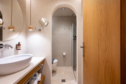 a bathroom with a sink and a toilet at Aegean Houses in Kos Town
