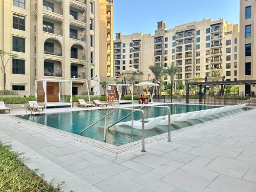 a swimming pool in a city with tall buildings at FIRST CLASS 1BR Classic Luxe Getaway in Dubai