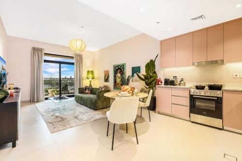 a kitchen and living room with a table and a couch at FIRST CLASS 1BR Classic Luxe Getaway in Dubai