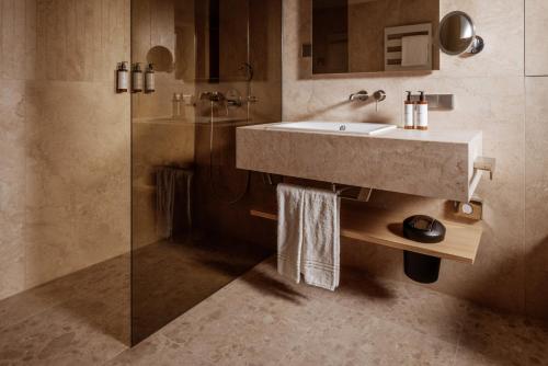 a bathroom with a sink and a shower at Hotel Auerhahn in Schluchsee