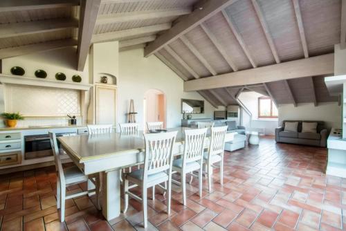 a kitchen and living room with a table and chairs at Mansarda Gentilino by Quokka 360 - Charming attic retreat in nature in Collina d'Oro