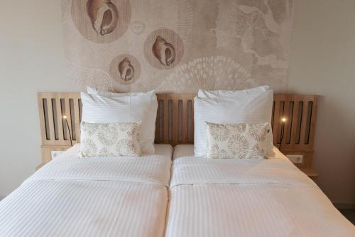 Katil atau katil-katil dalam bilik di Beachfront Boutiquehotel