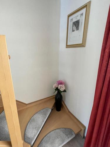 a stairwell with a vase of flowers in a room at Egon in Neuruppin
