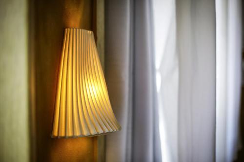a yellow lamp is next to a window at Neot Semadar Eco Lodge in Naẖal Ya‘alon
