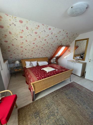 a bedroom with a bed with a red bedspread at Egon in Neuruppin