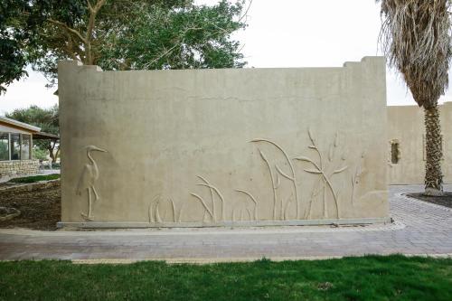 a concrete wall with some graffiti on it at Neot Semadar Eco Lodge in Naẖal Ya‘alon