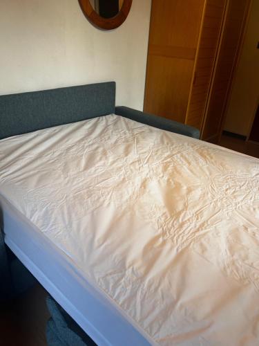 a bed with white sheets on it in a room at Studio la Gioia in Allos