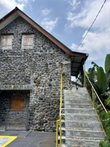 a stone building with stairs in front of it at Galunggung Basecamp Villa 