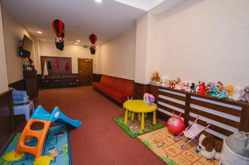 a living room with a couch and many toys in it at Hotel Lesana in Vysoké Tatry