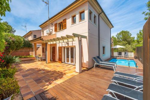 a house with a swimming pool and a deck at Tomymar in Cala Ratjada