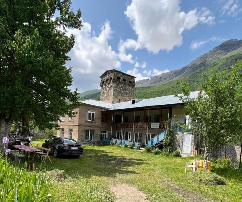 a large building with a tower on top of it at Guesthouse Tanano/Dodo in Zhabeshi