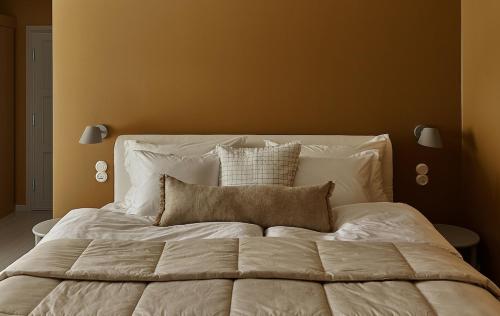 a bedroom with a large white bed with two pillows at Stay North - Matri House in Mathildedal